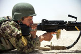 An Afghan National Army soldier fires an M240B machine gun during a live-fire exercise .